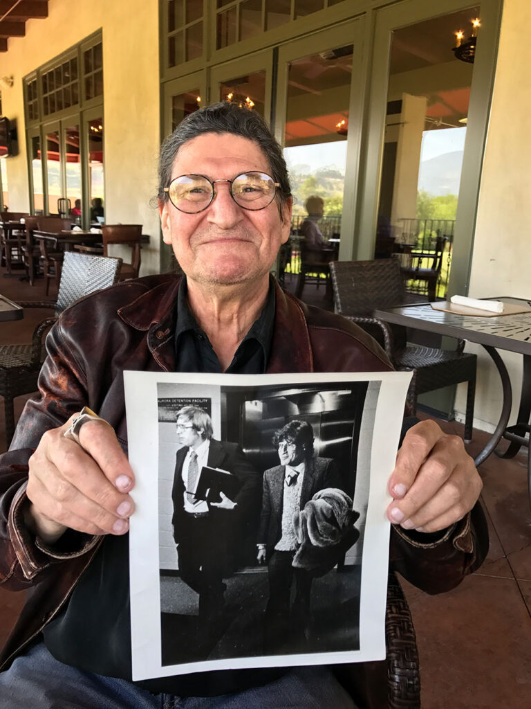 Barry holds a photo of his younger self.